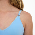 Close-up of a light blue SASSH Essential training bra showing bow strap detail and seamless underband — girls seamless training bra, first bra.