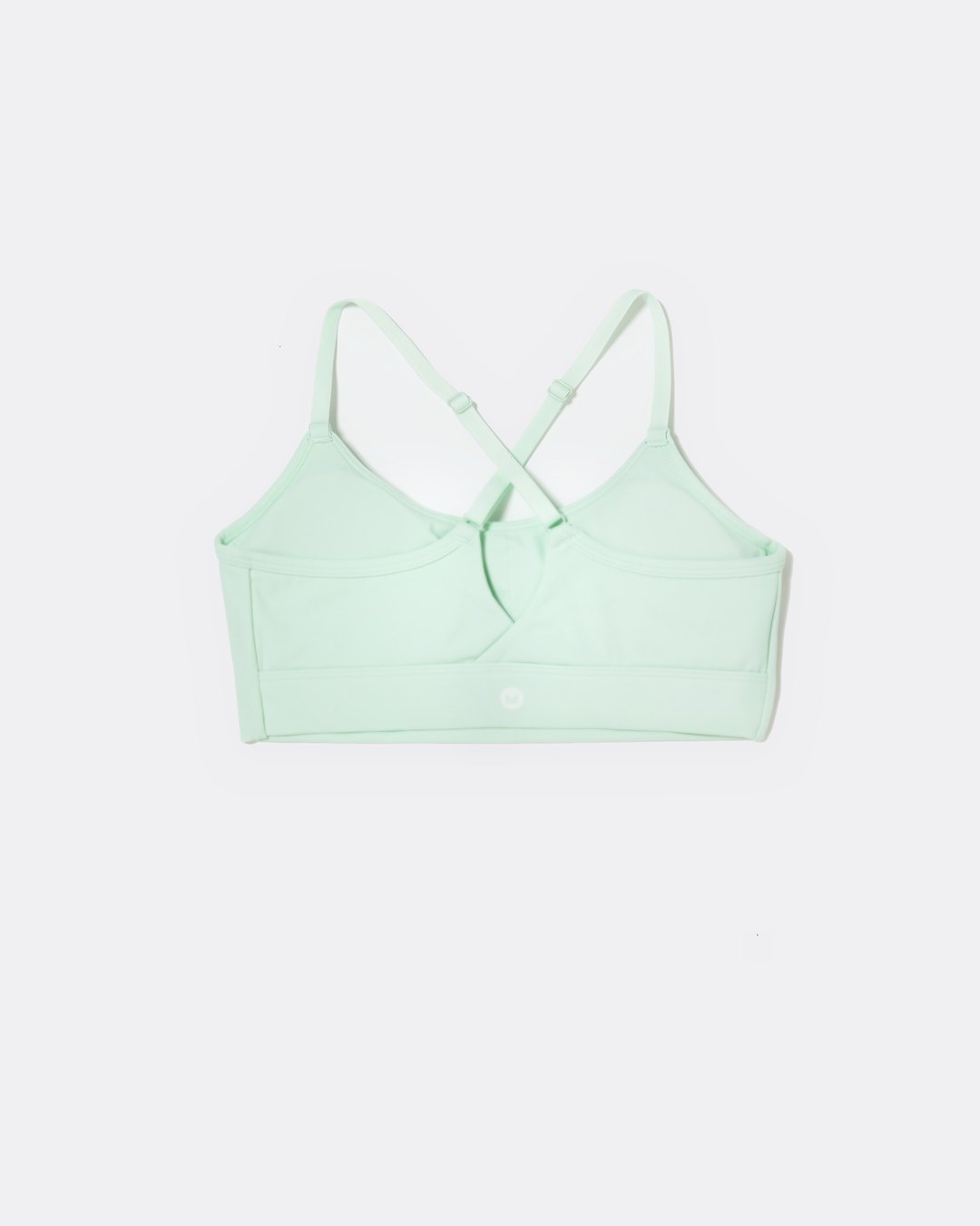 SASSH The Energy sports bra in mint green, back ghost view, showing crossover racerback strap detail — girls sports bra, first sports bra.