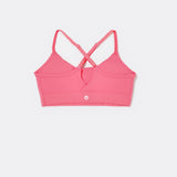 SASSH The Energy sports bra in hot pink, back ghost view, showing crossover racerback strap detail — girls sports bra, first sports bra.