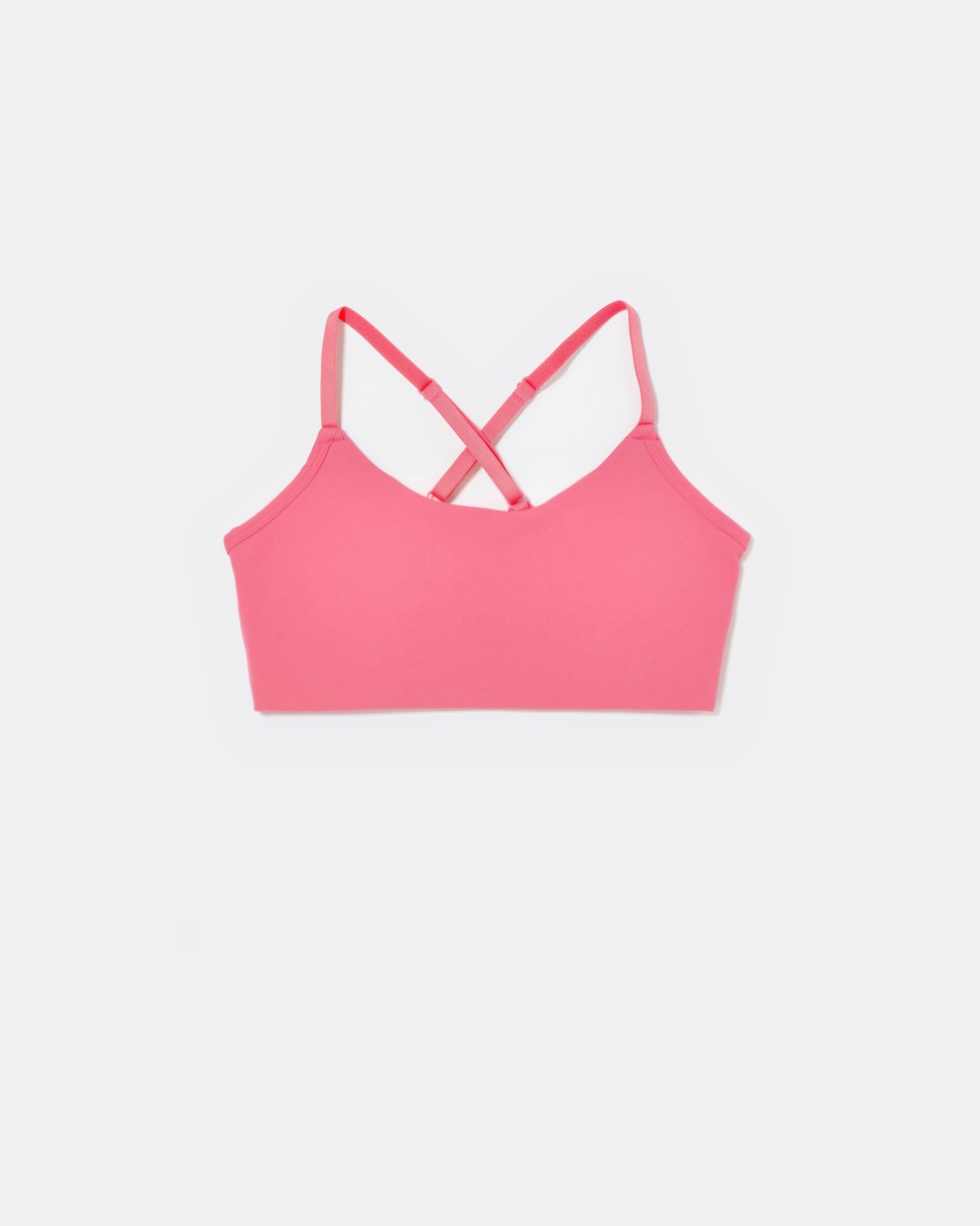 SASSH The Energy sports bra in hot pink, front ghost view, smooth scoop neckline and seamless underband — girls sports bra for tweens.