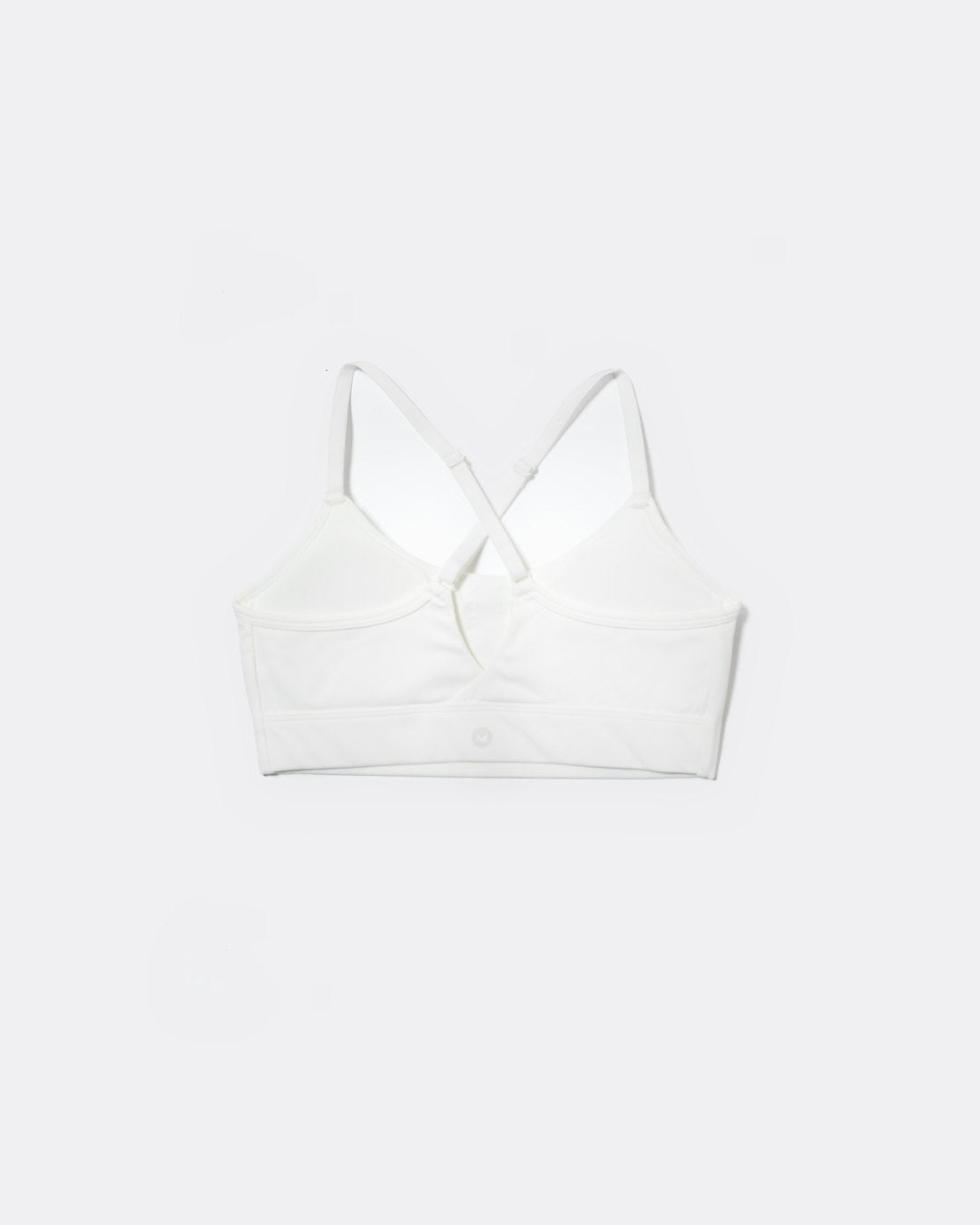 SASSH The Energy sports bra in white, back ghost view, showing crossover racerback strap detail — girls sports bra, first sports bra.