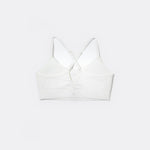 SASSH The Energy sports bra in white, back ghost view, showing crossover racerback strap detail — girls sports bra, first sports bra.