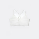 SASSH The Energy sports bra in white, back ghost view, showing crossover racerback strap detail — girls sports bra, first sports bra.
