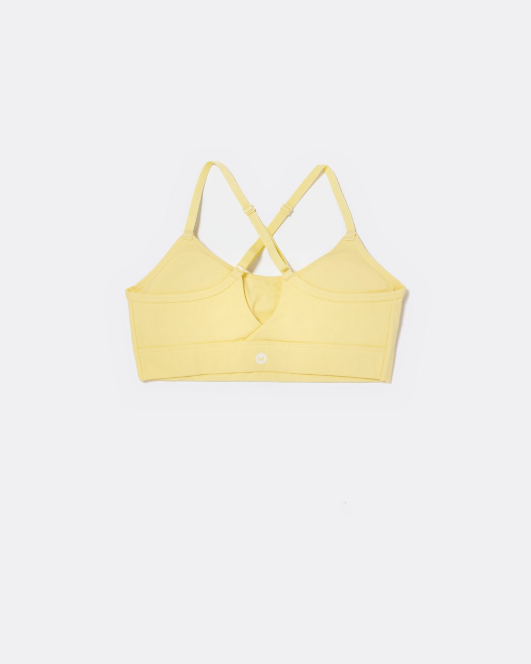 SASSH The Energy sports bra in yellow, back ghost view, showing crossover racerback strap detail — girls sports bra, first sports bra.